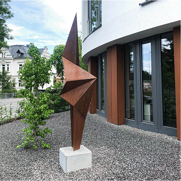 Outdoor sculpture in corten steel in a second variation of the abstract interpretation of the kelp leaf shape in a more origami-like appearance