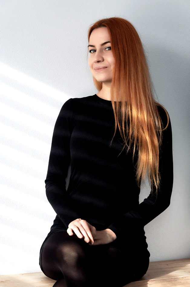 Portrait of the designer with ginger hair in black dress