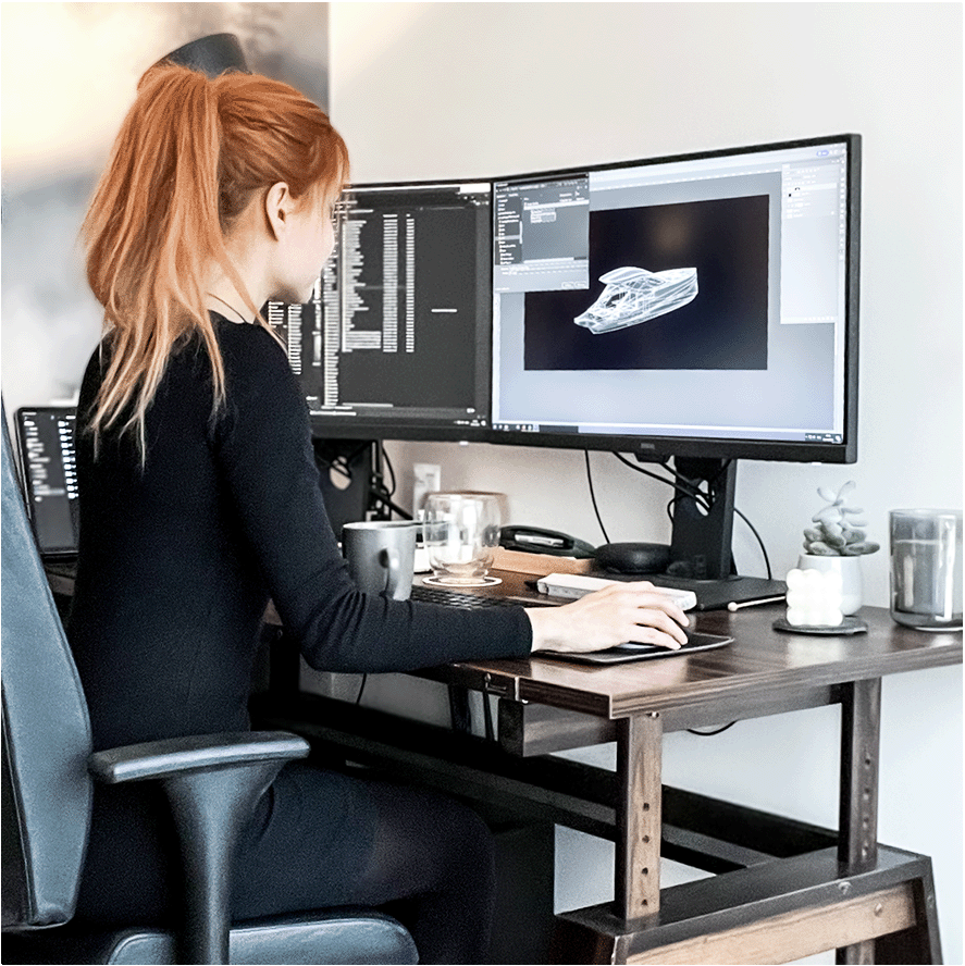 Photo of a designer Mara in her office working on the computer on a yacht design